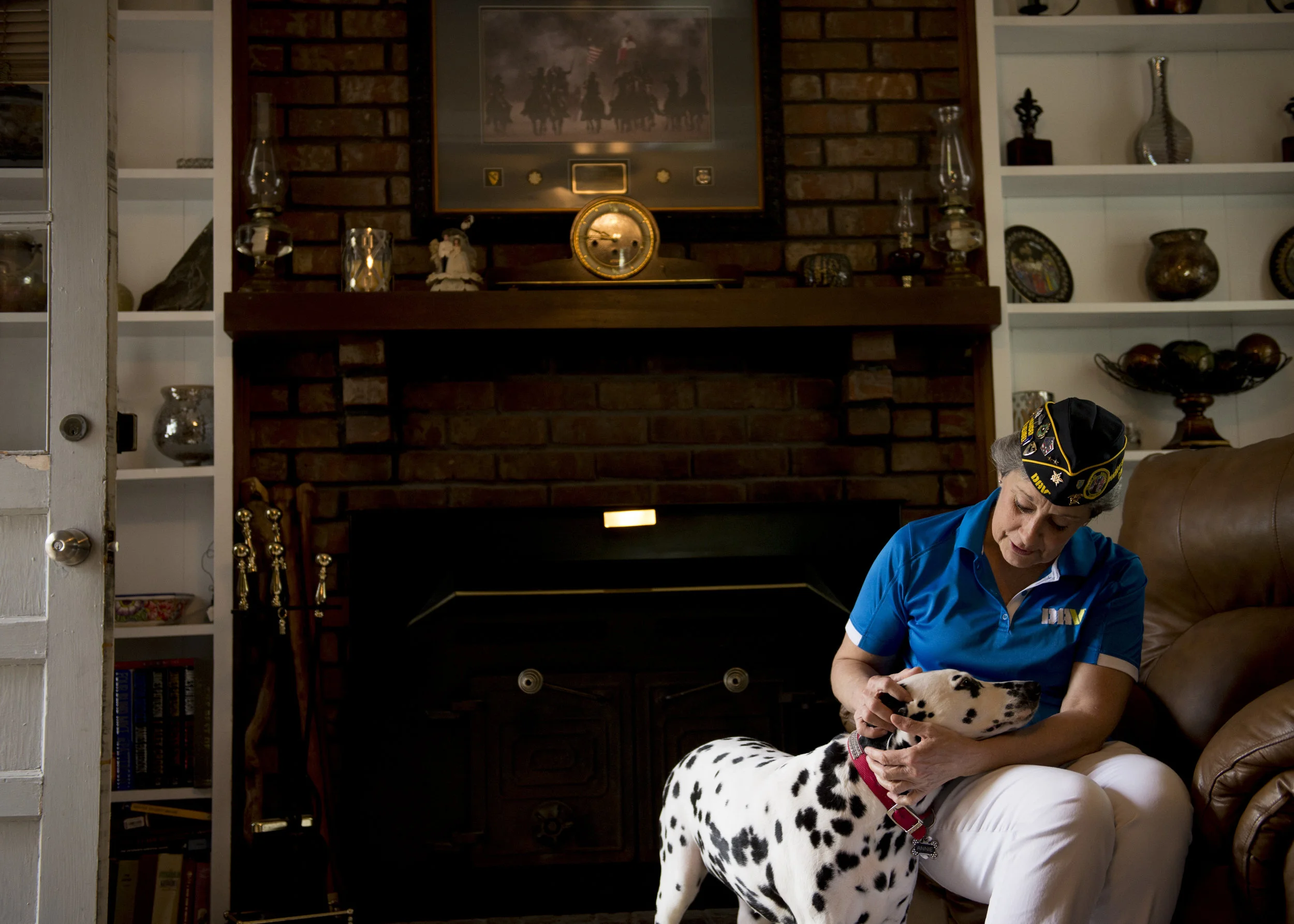  Becky Smith, commander of the local Disabled American Veterans chapter, pets her dog Annie in her home in Clarksville. 