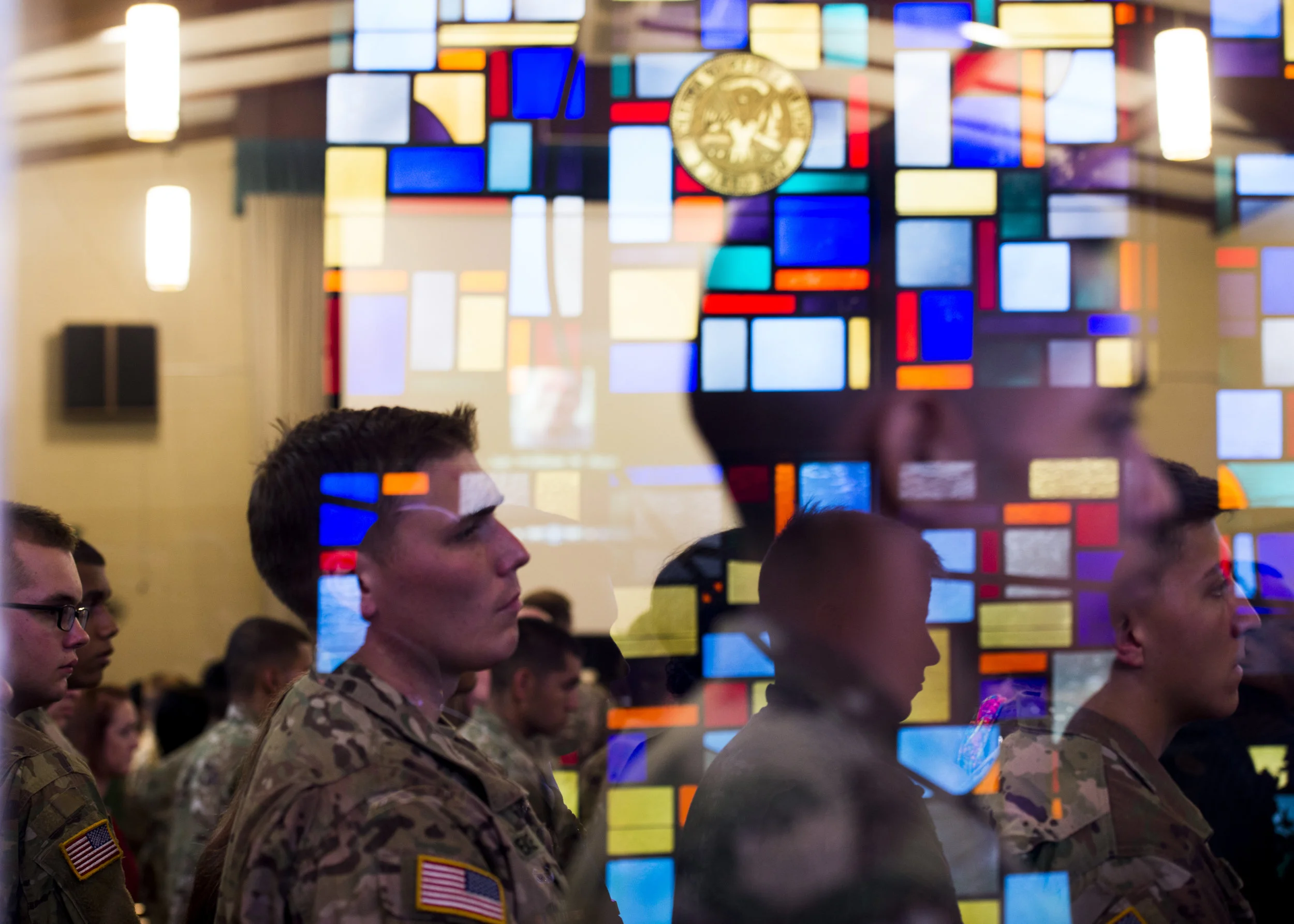  Soldiers watching the casket with Sgt. William Bays carried down the aisle are reflected in the glass of the chapel on June 23, 2017.&nbsp; 