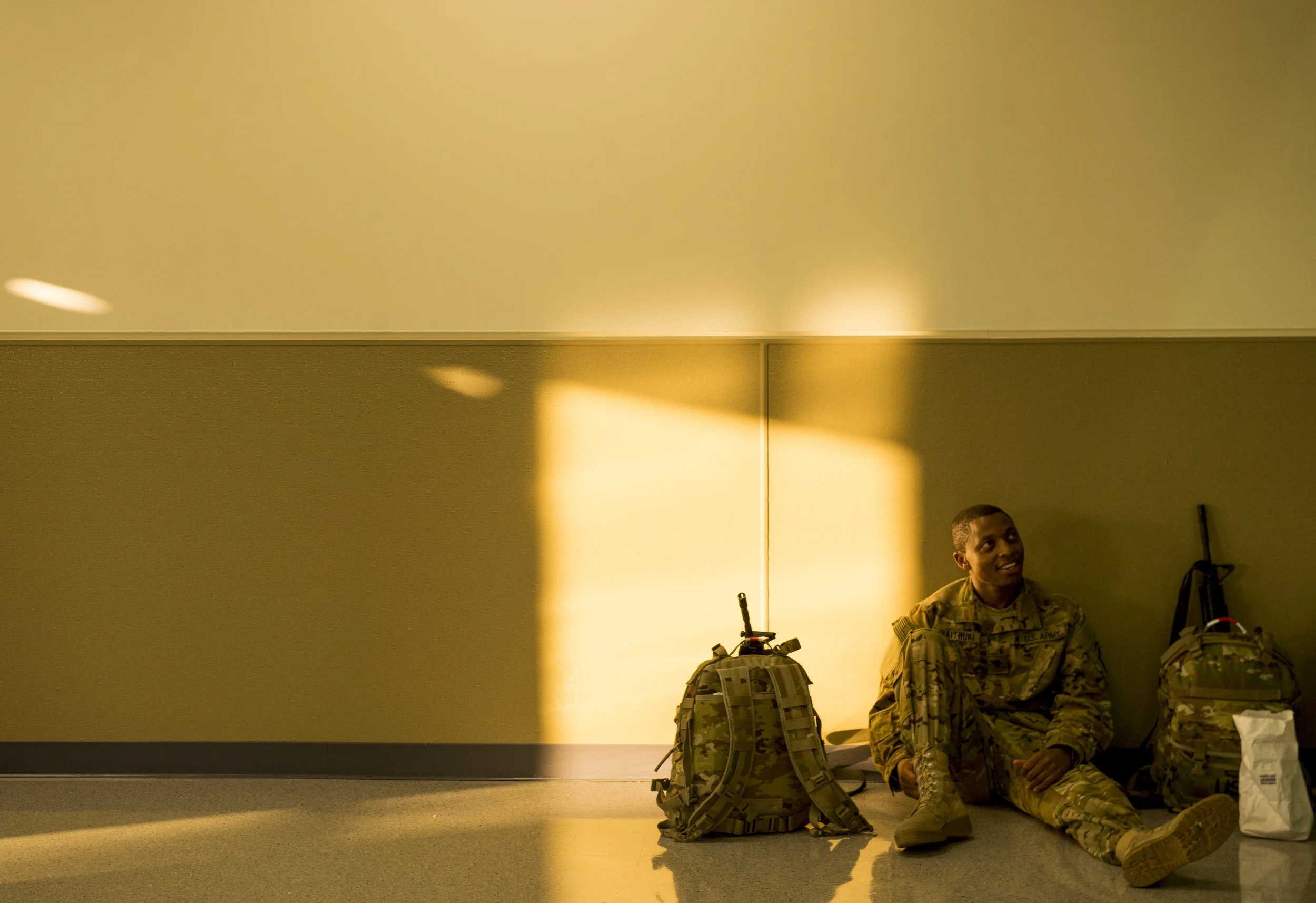  Kelvin Waithuki waits before boarding his flight to Southwest Asia with the 2nd Squadron, 17th Cavalry Regiment on August 8, 2017. Waithuki and 300 other soldiers will be gone on a 9-month deployment. 