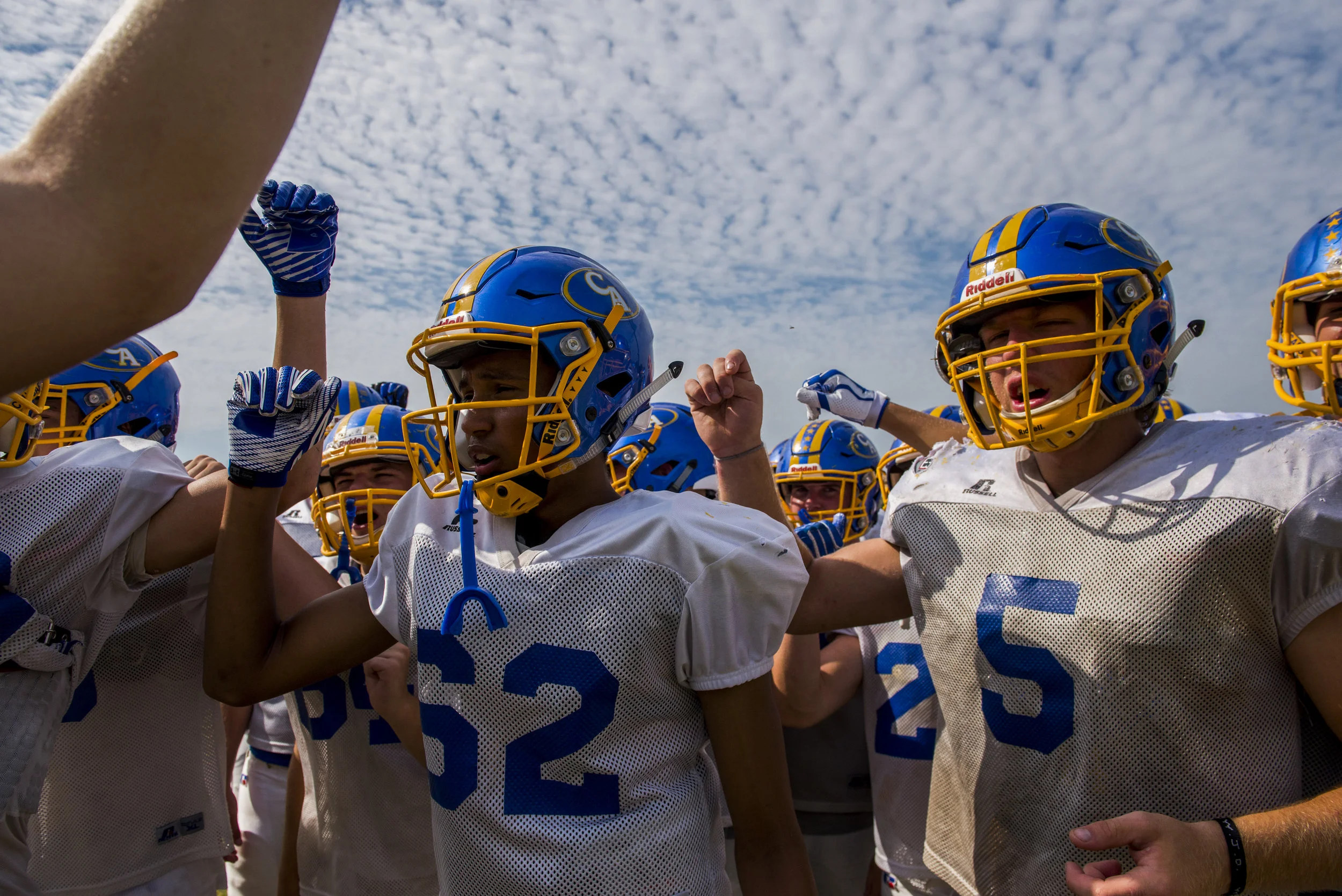  Clarksville Academy players huddle and cheer during their first football practice of the season on July 24, 2017. 