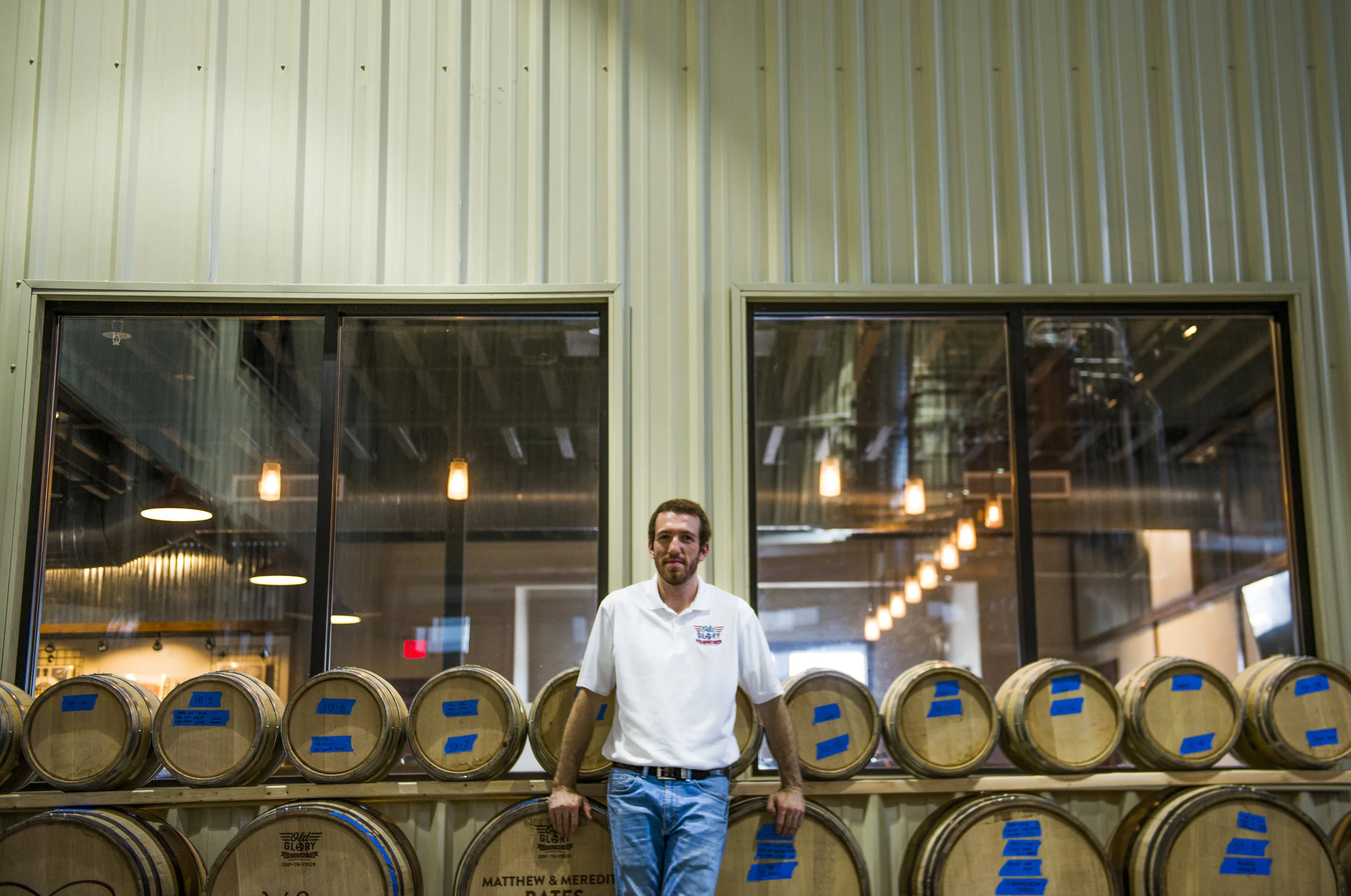  Matt Cunningham, proprietor of Old Glory Distillery, poses for a portrait next to aging whiskey barrels on July 19, 2017.&nbsp; 