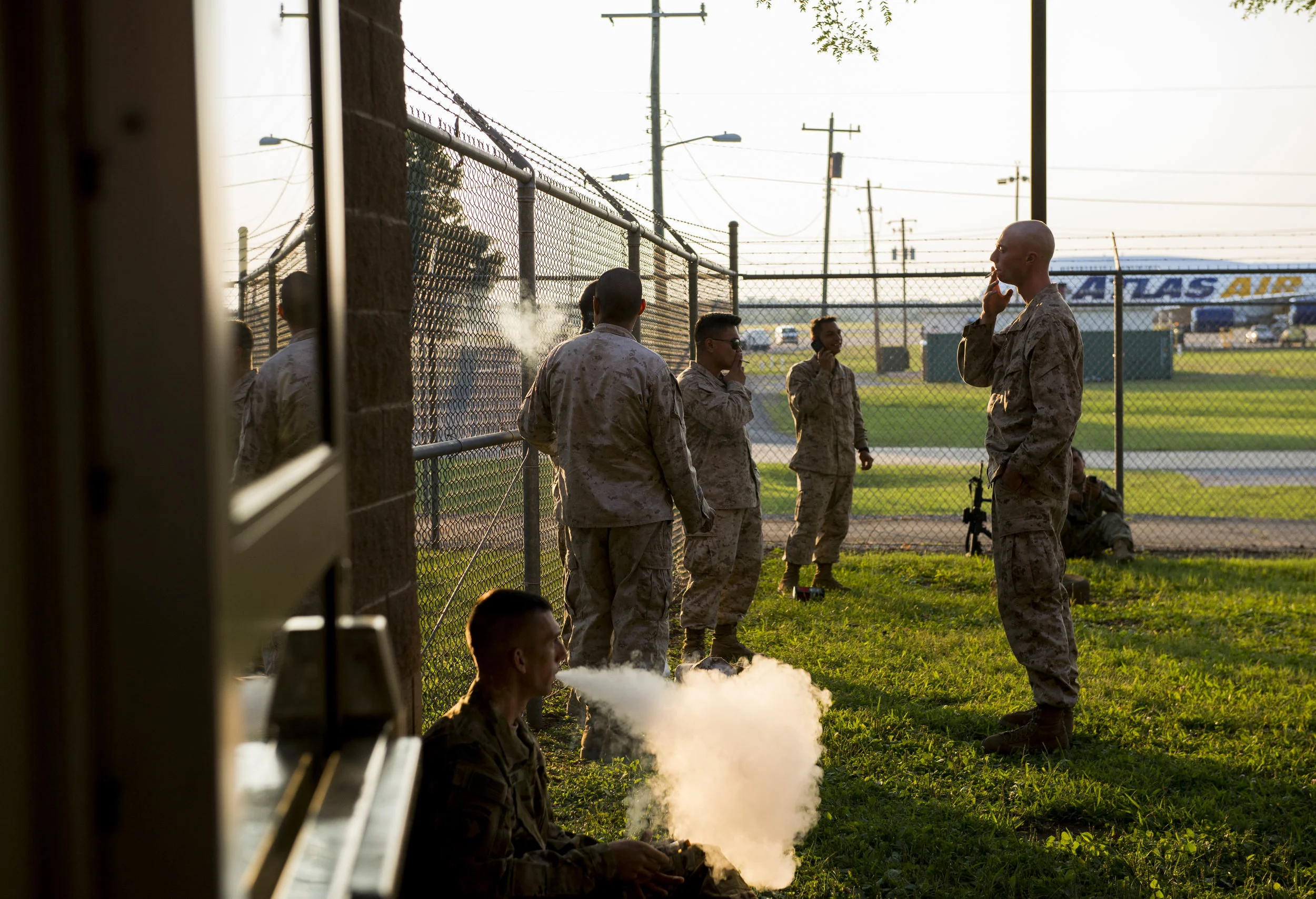  Marines stand outside to relax and smoke before being deployed to Southwest Asia for a 9-month deployment. 