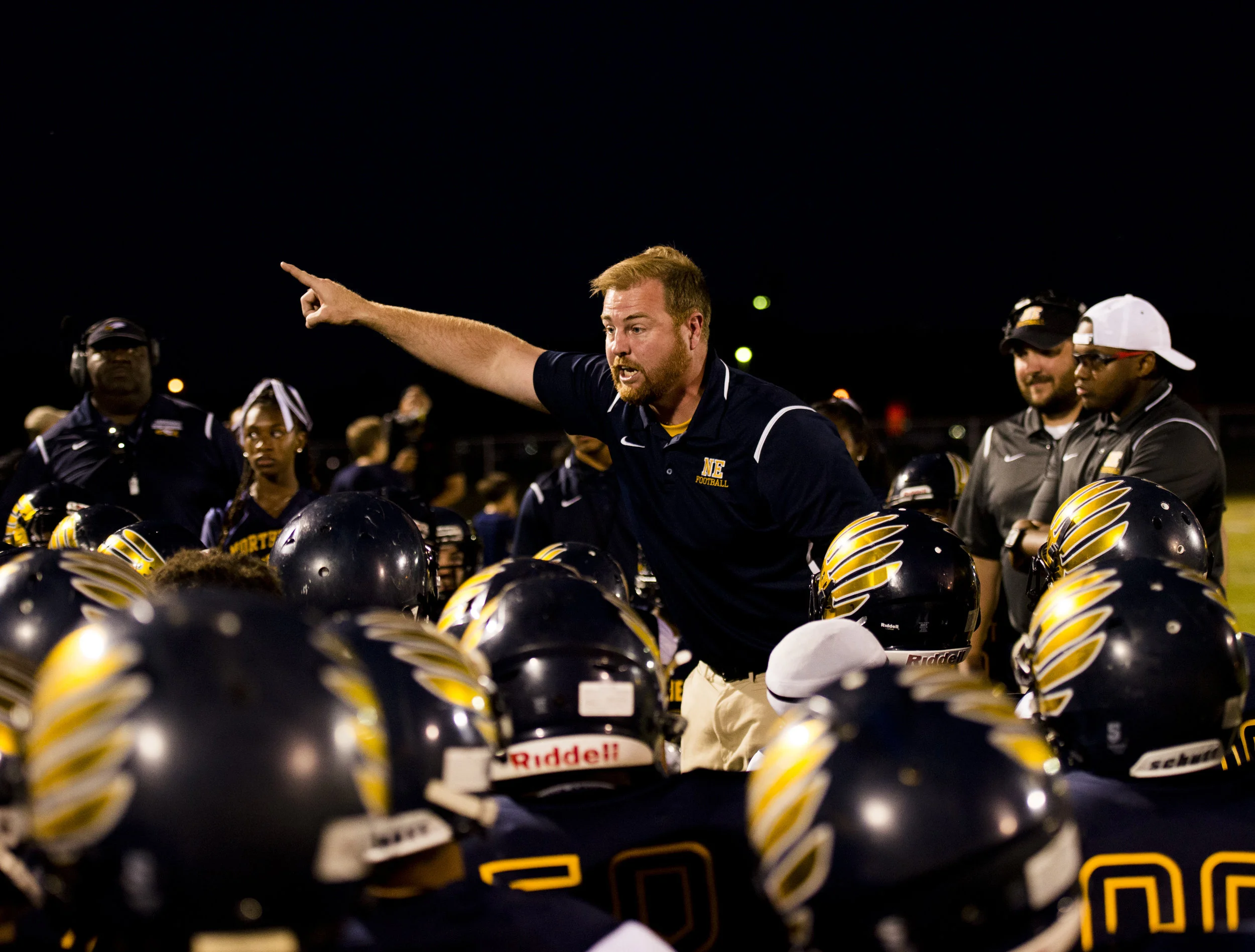  Northeast Head Coach Chad Watson yells at his team after they ran across the lines following their first touchdown during their game against Rossview High School. 
