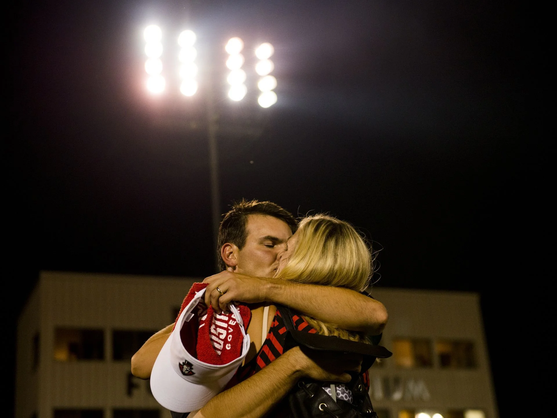  Austin Peay Head Coach Will Healy holds and kisses his wife Emily after winning their game against Morehead State on September 16, 2017, breaking the longest losing streak in Division 1 college football. 