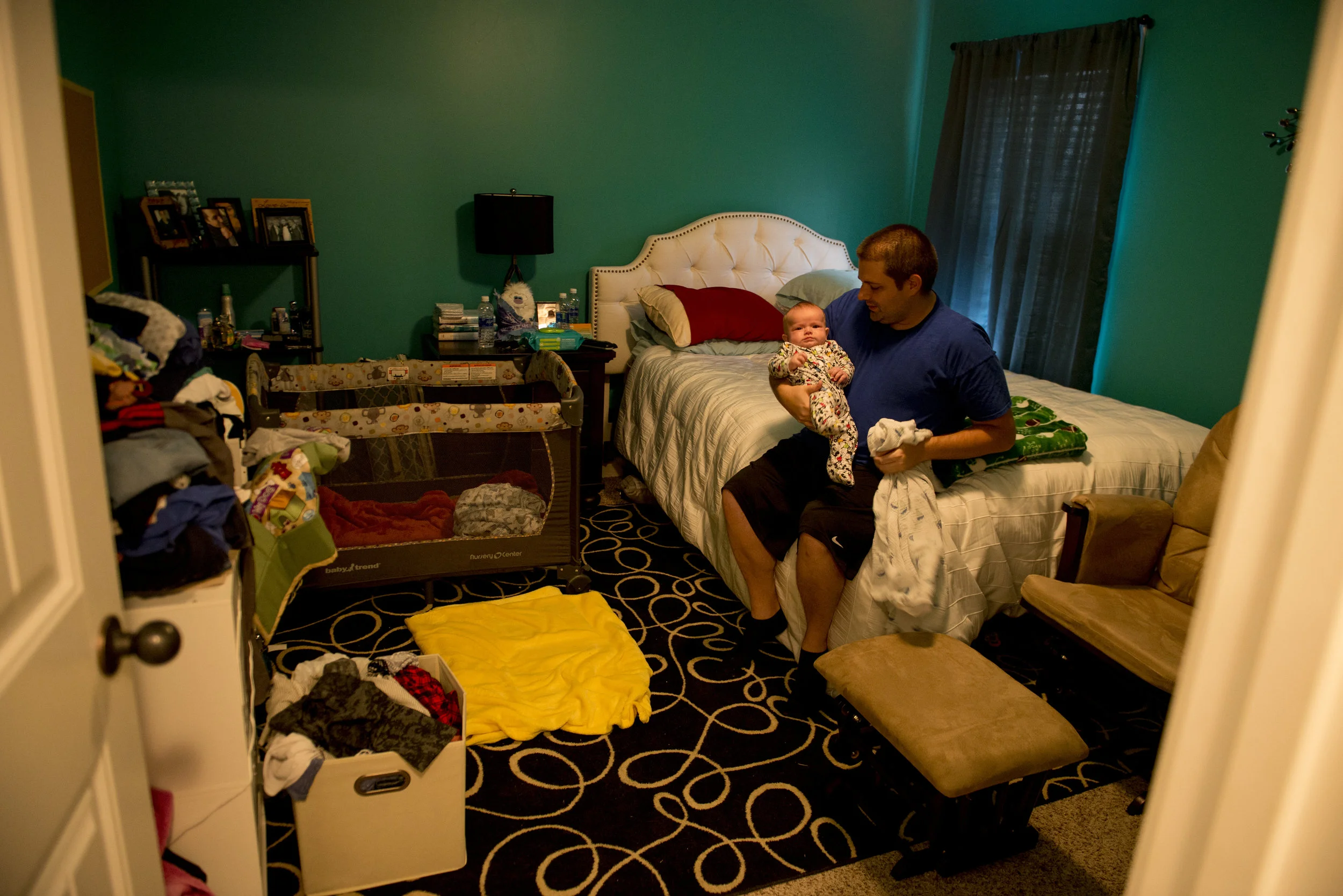  Michael Madden holds his 12-week-old son Lucas among a crowded room of clothing, baby supplies and a crib after having to evacuate from Port Charlotte, Fl with 9 other people following Hurricane Irma. 