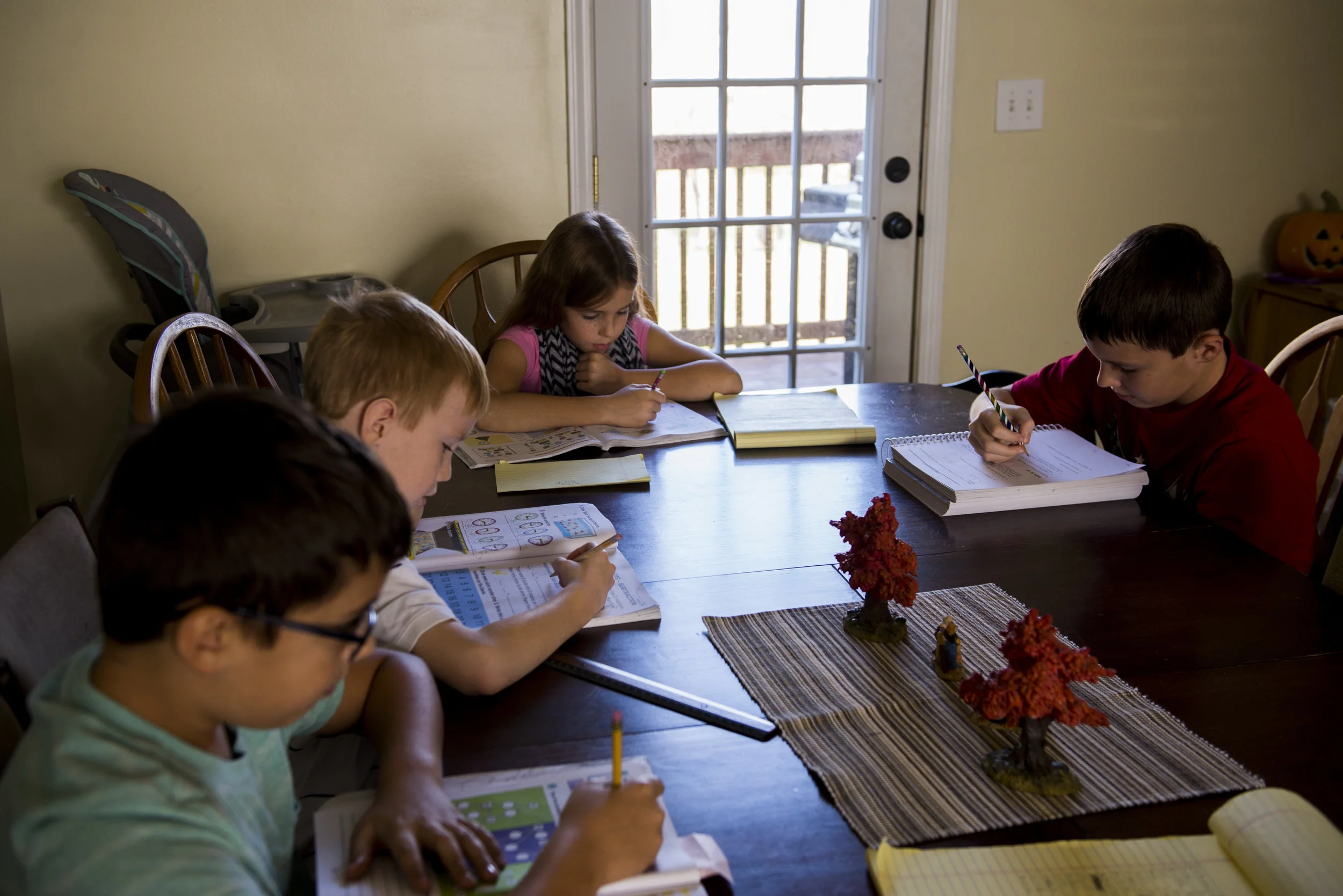  From left, Bennett, 10, Russell, 7, Camille, 9, and Mitchell, 13, all work on their school work at the kitchen table on November 10, 2017.  http://leafne.ws/2zC6GLq 