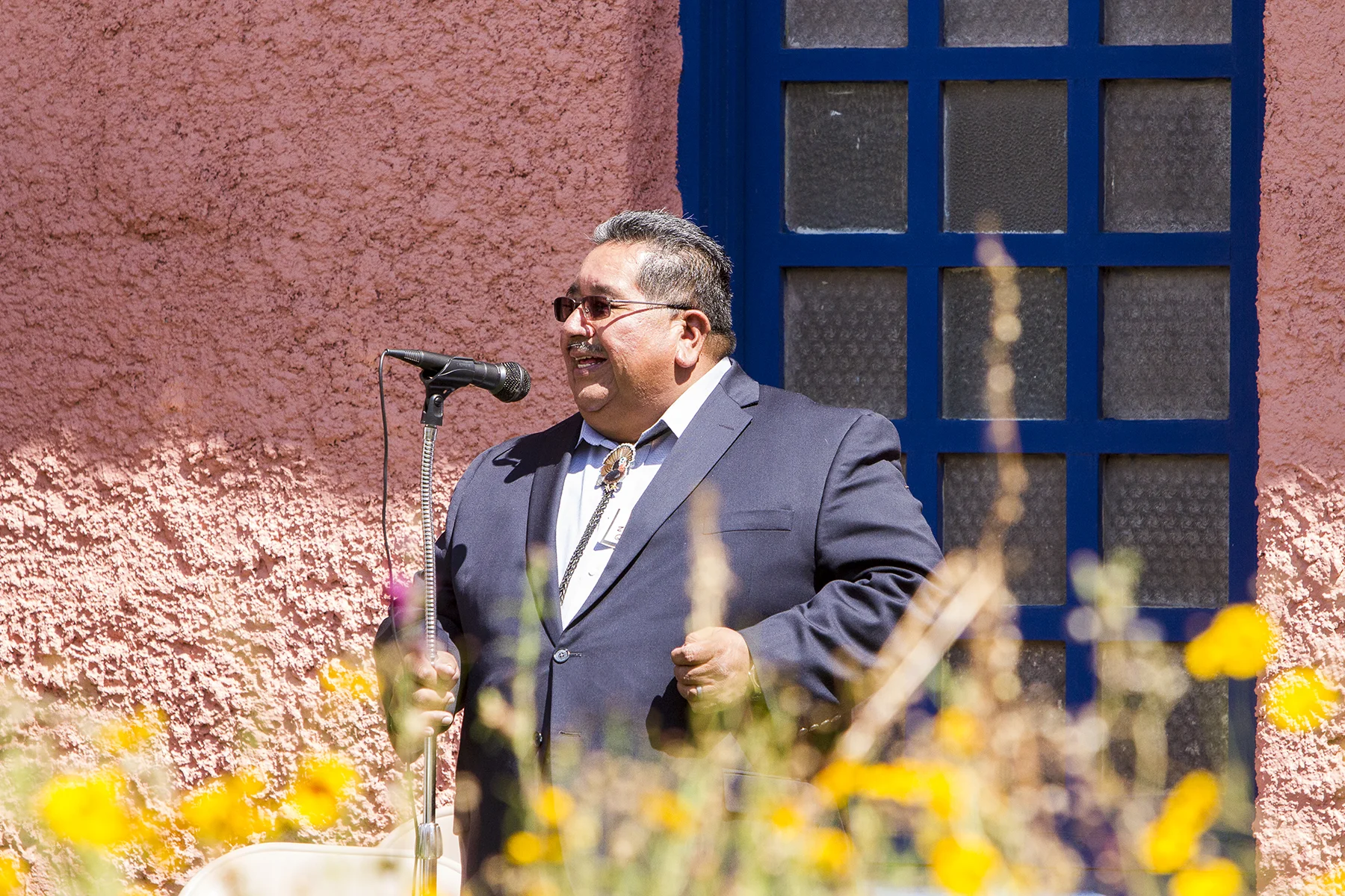 Zuni Pueblo Governor Val Panteah addressing the crowd in the courtyard.