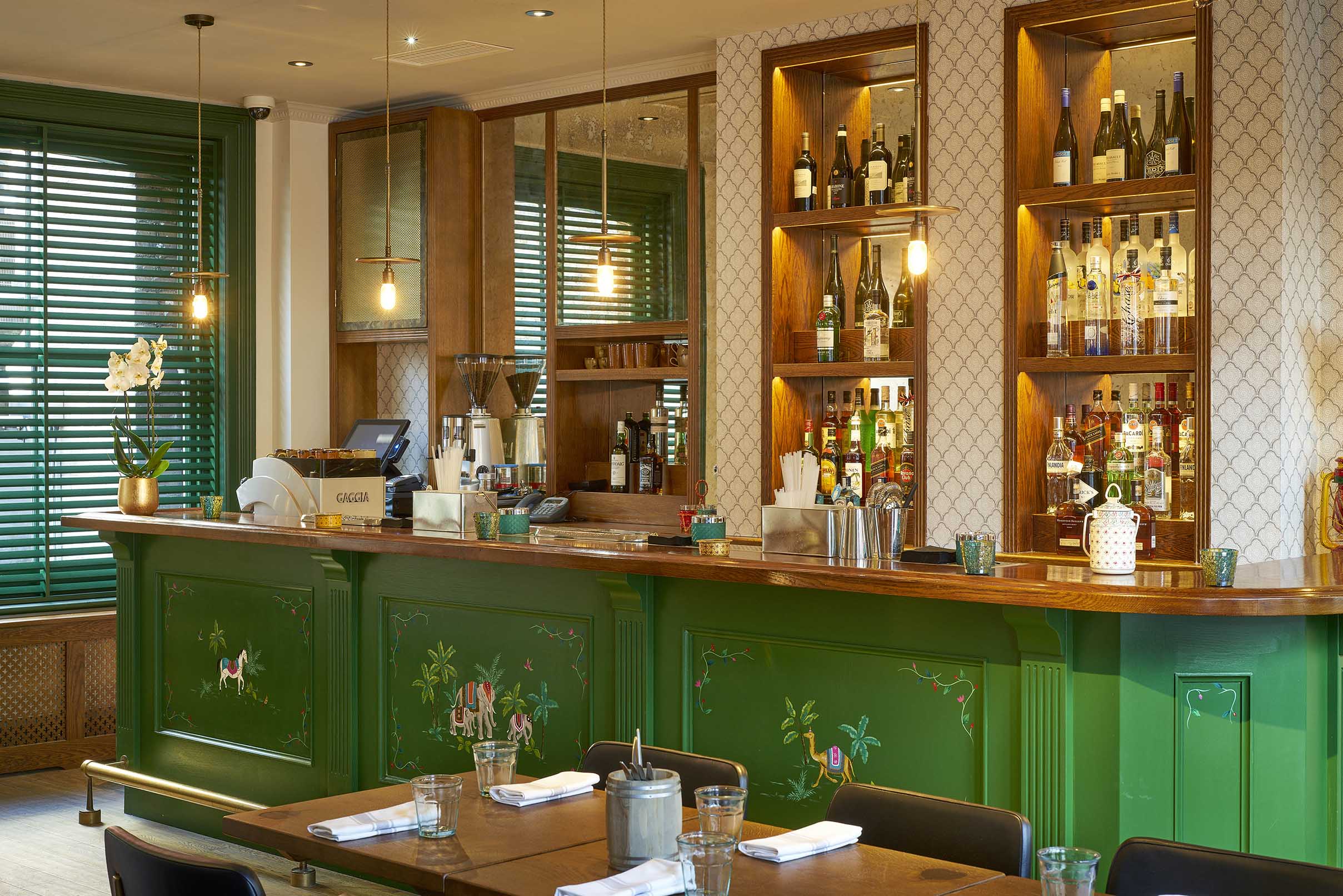 Hand-painted elephant and palm scenes applied to the bar front of the private dining room.