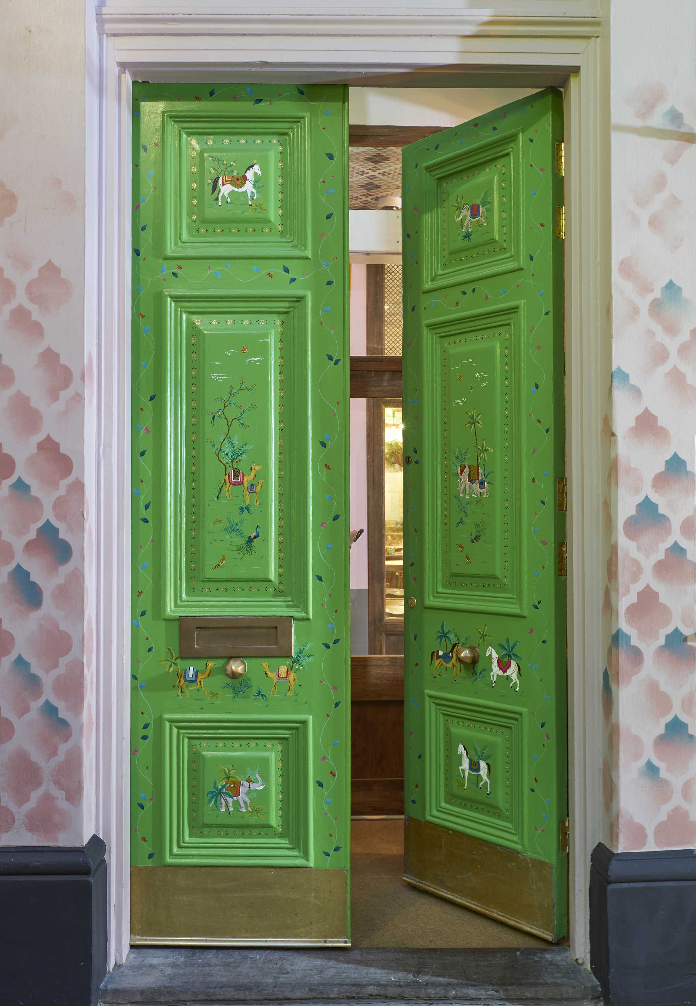 Entrance doors hand-painted with animal scenes and decorative borders.
