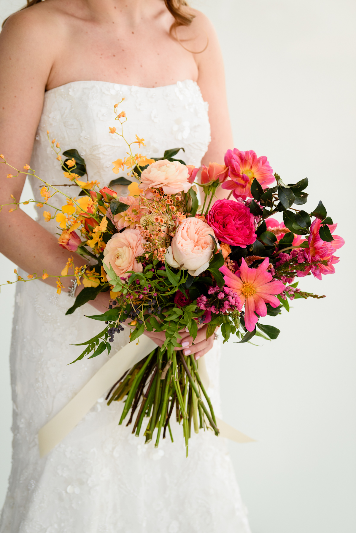 Pink, peach, yellow bouquet by Putnam and Putnam