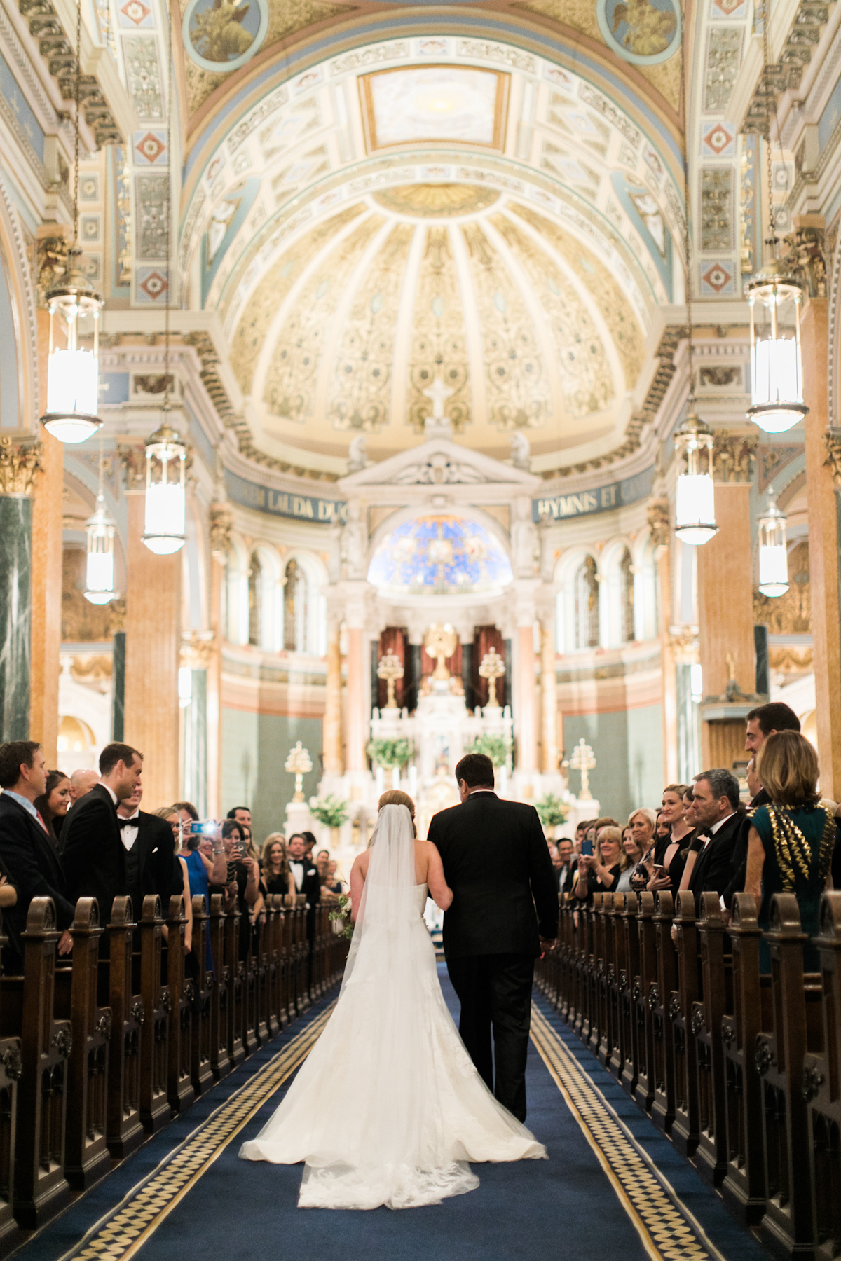 Bride walking down the aisle at St Jean Baptiste Church