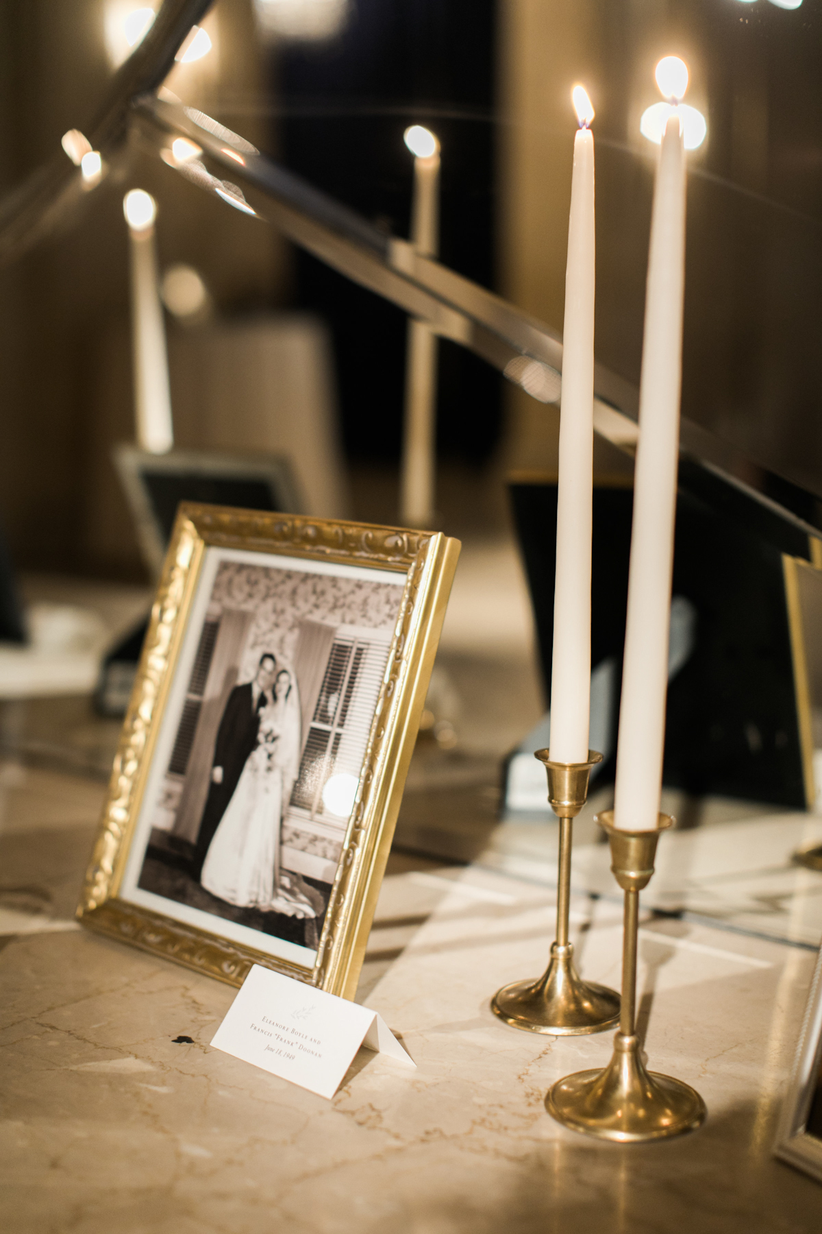 Framed family wedding photos with taper candles at Plaza wedding