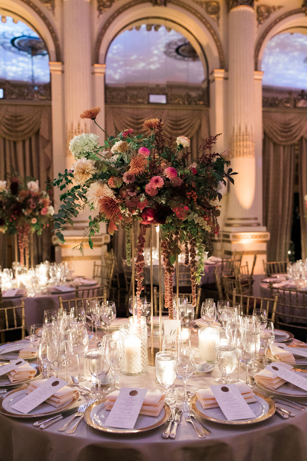 Plaza wedding tablescape with flowers, candles and chargers