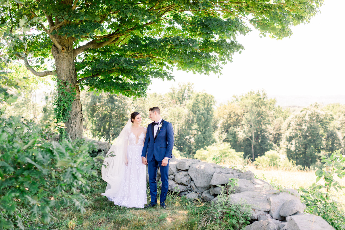 Bride and groom in front of a tree at Blue Hill at Stone Barns