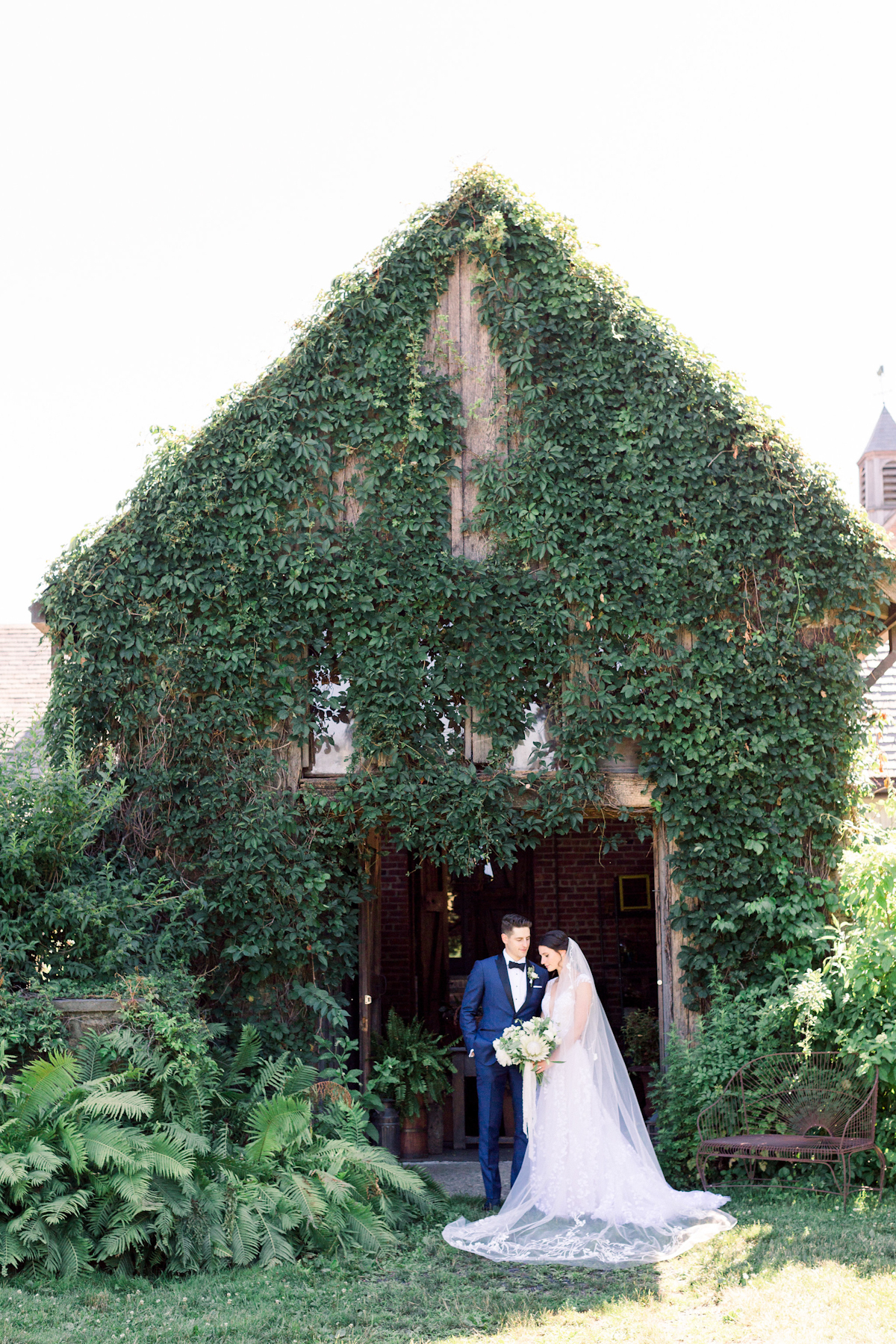 Bride and groom in front of ivy covered shed at Blue Hill at Stone Barns wedding