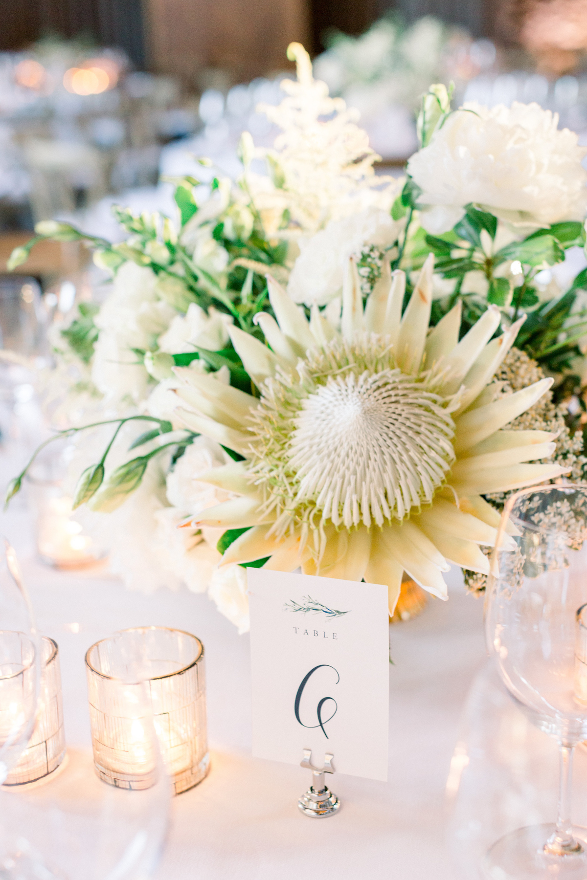 Blue Hill at Stone Barns wedding table number sign and white protea floral centerpiece