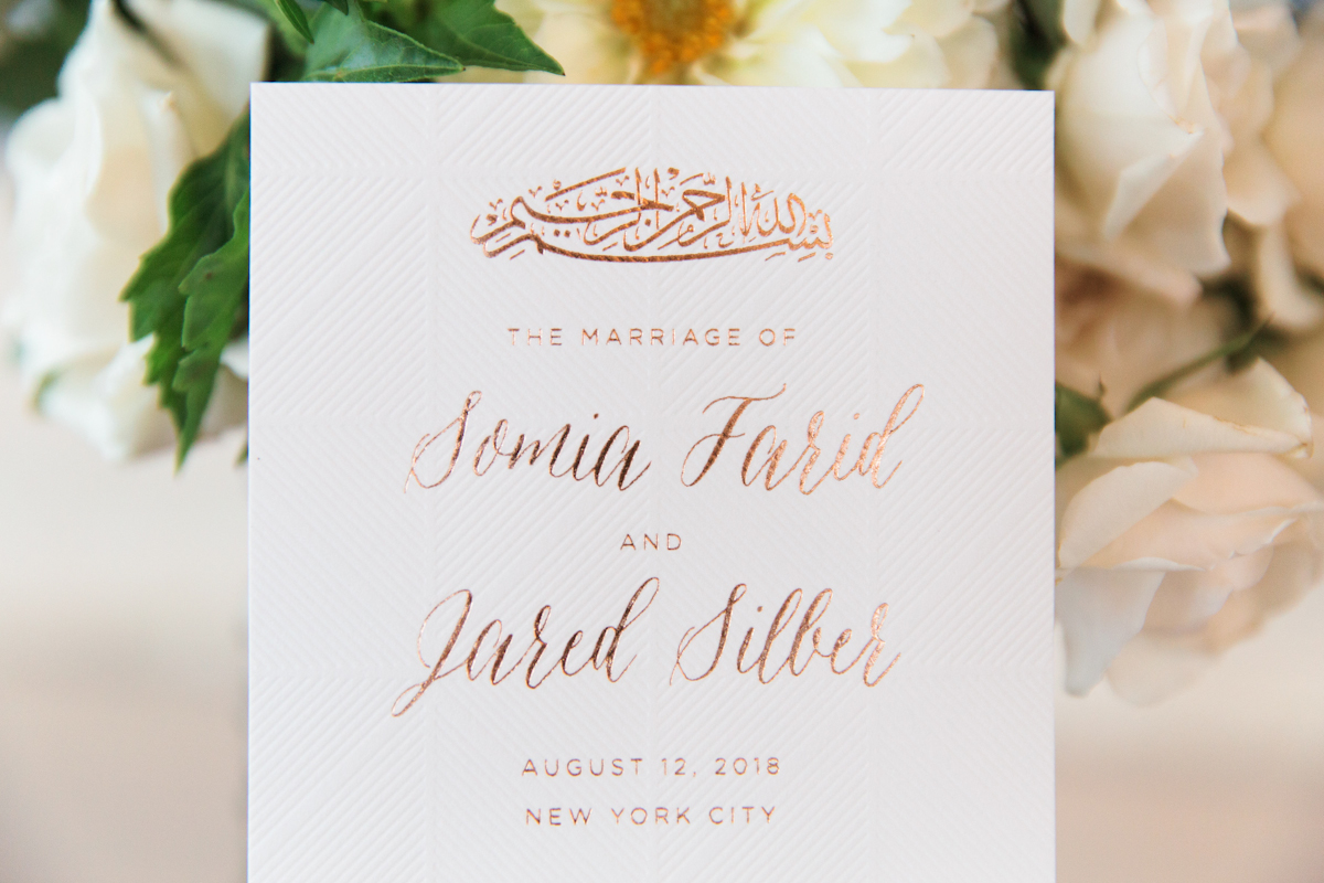 South asian Rainbow Room wedding ceremony program with foil details