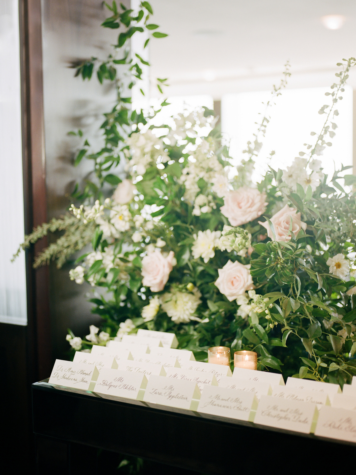 Escort card table flowers and calligraphed cards at Rainbow Room wedding