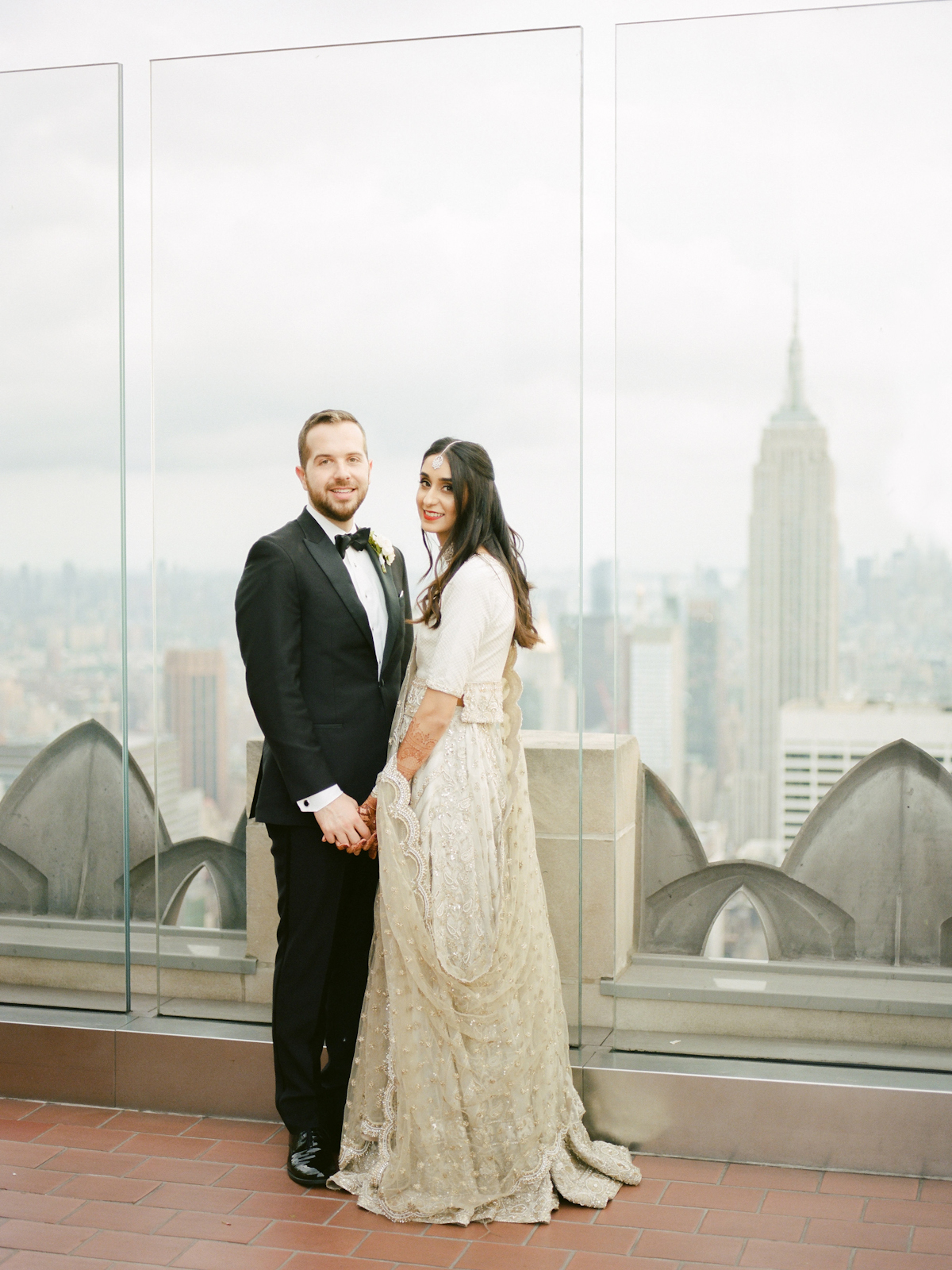 South asian bride and groom in tuxedo at Rainbow Room wedding