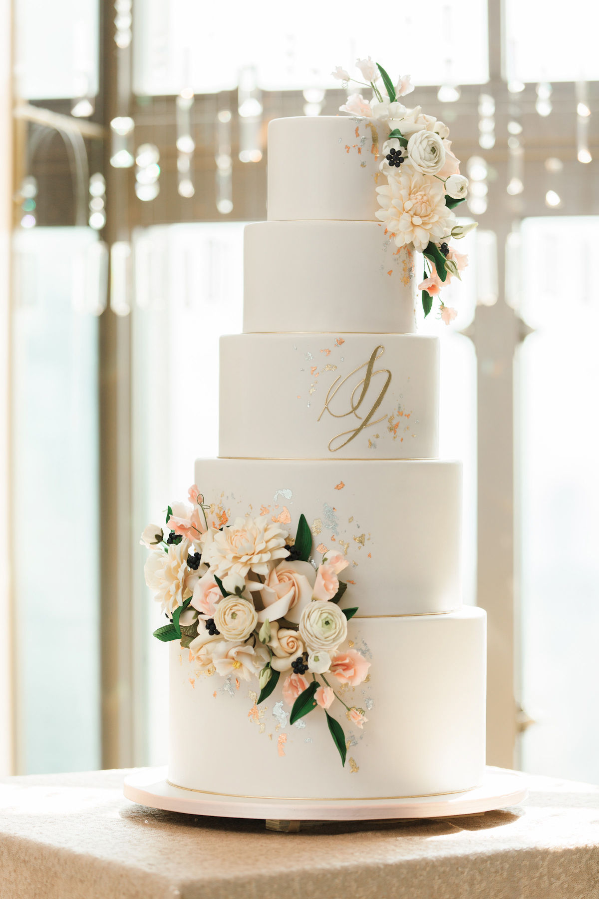 Wedding cake with flowers and metallic accents at Rainbow Room wedding