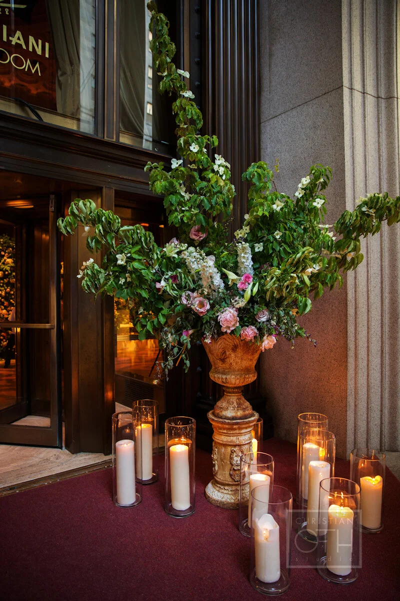 Cipriani Wall Street Wedding flowers and candles at the entrance