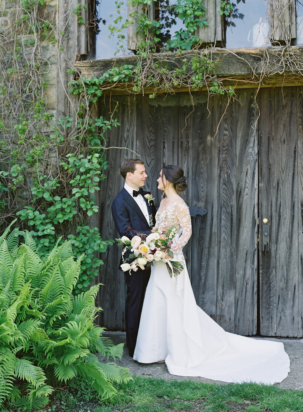 Blue Hill at Stone Barns Wedding bride and groom in front of barn door