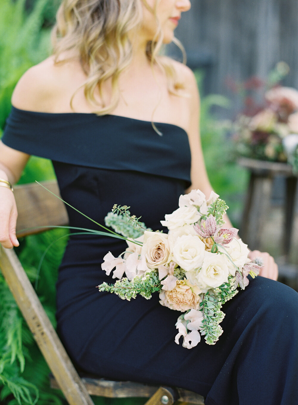 Blue Hill at Stone Barns Wedding bridesmaids in one shoulder black gown holding a bouquet of lowers