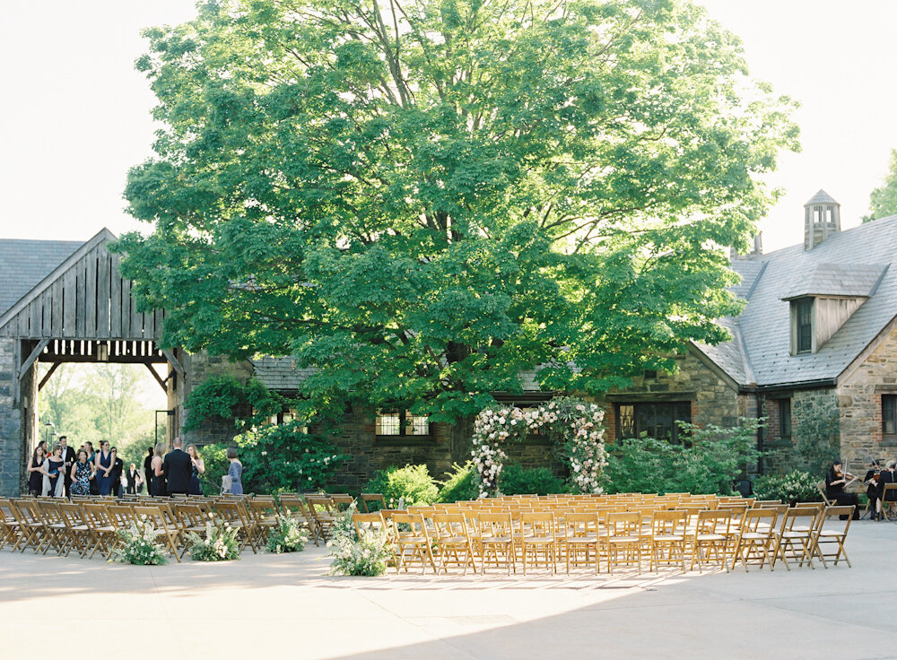 Blue Hill at Stone Barns wedding ceremony floral arch in the courtyard