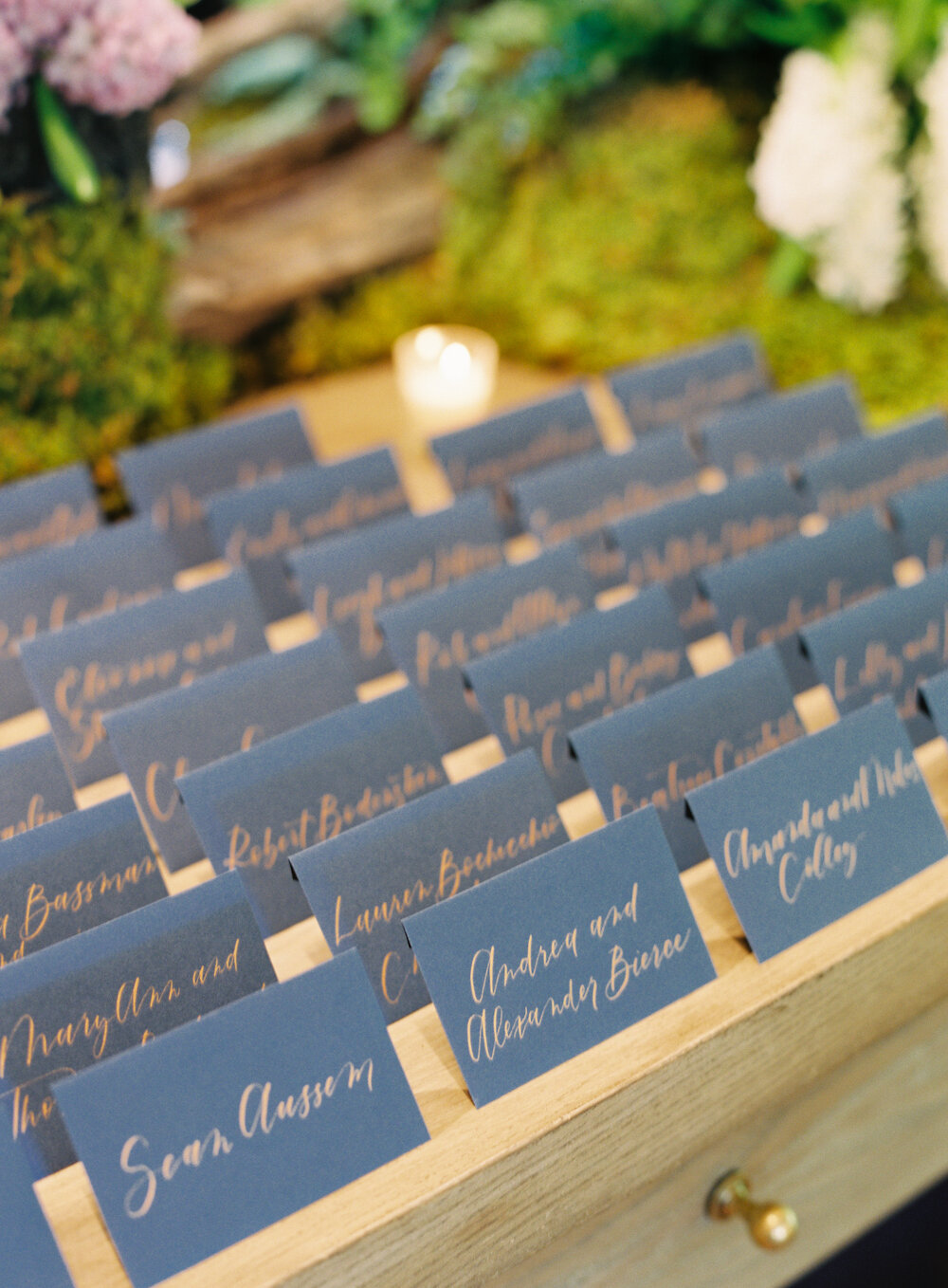 Blue Hill at Stone Barns wedding escort cards with gold calligraphy on navy