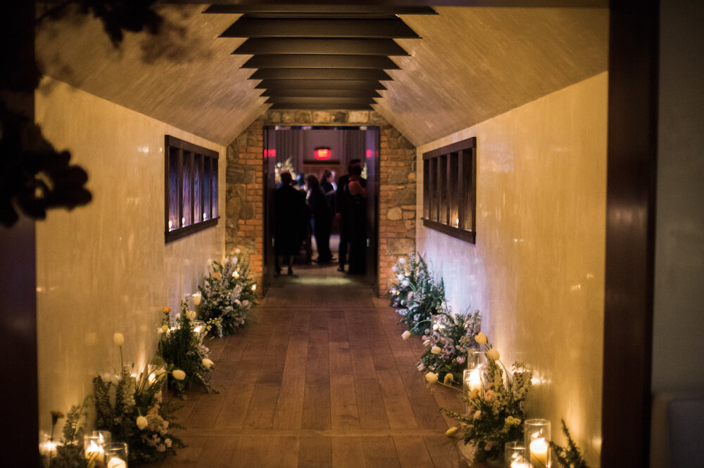 Blue Hill at Stone Barns wedding hayloft hallway lined with flowers and candles 