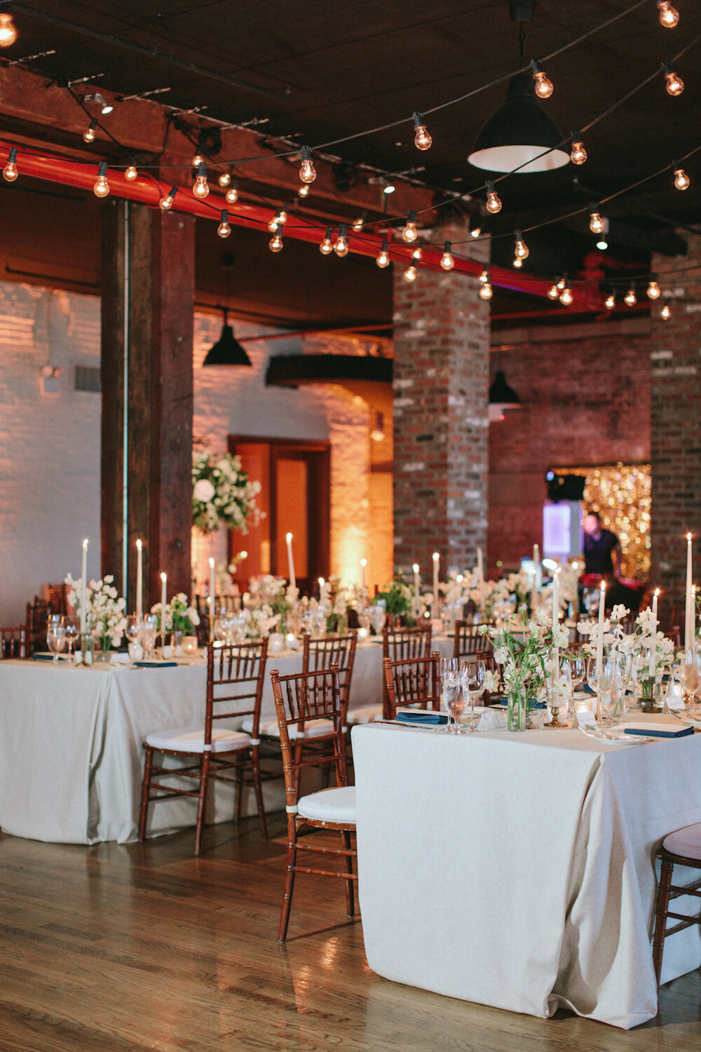 long tables with flowers and taper candles.jpg