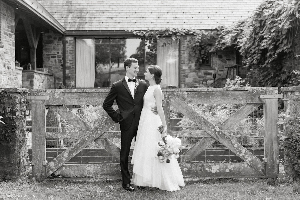 Blue Hill at Stone Barns wedding bride groom in front of wooden gate