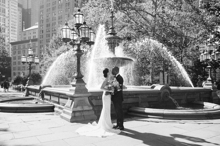 Four Seasons NYC wedding bride and groom in city hall park in front of fountain