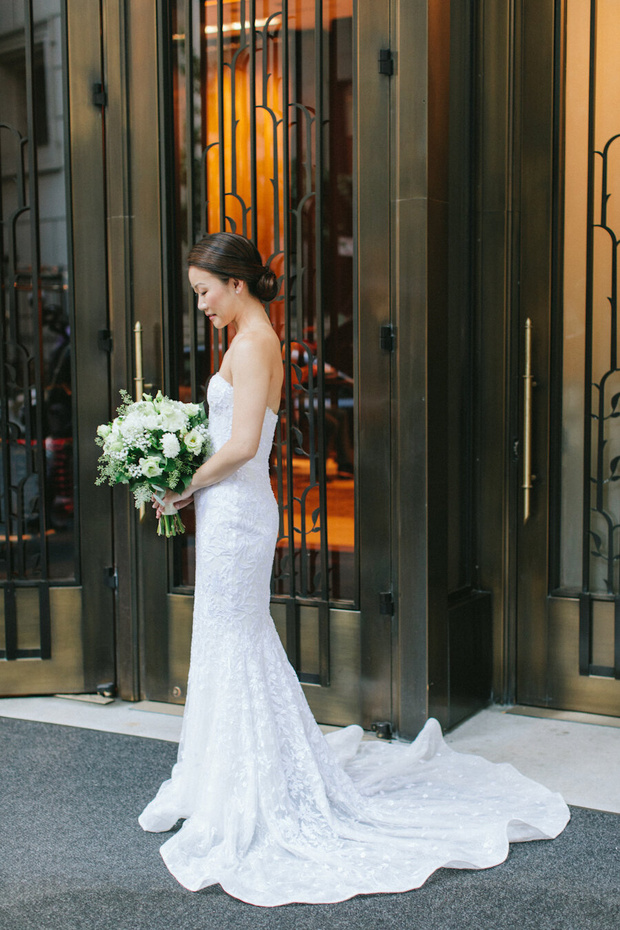 Four Seasons NYC wedding bride holding white bouquet wearing mermaid gown