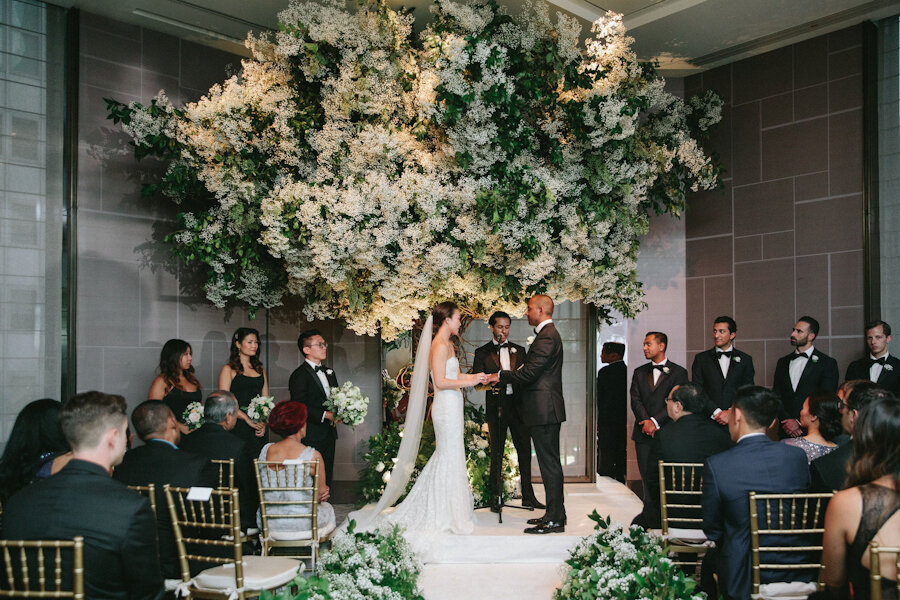Four Seasons NYC wedding ceremony bride and groom in front of large tree