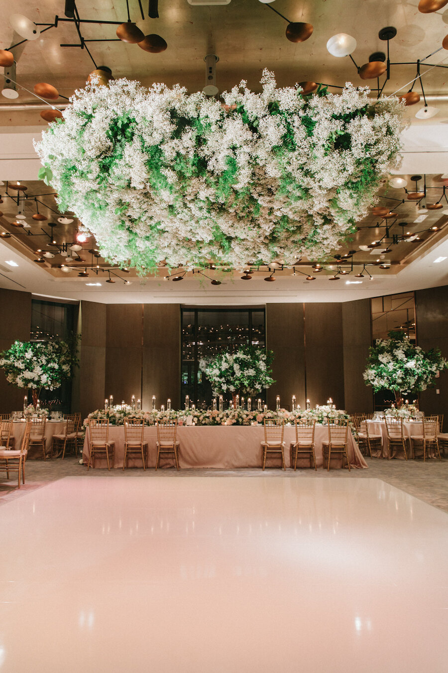 Four Seasons NYC wedding hanging flowers over white dance floor
