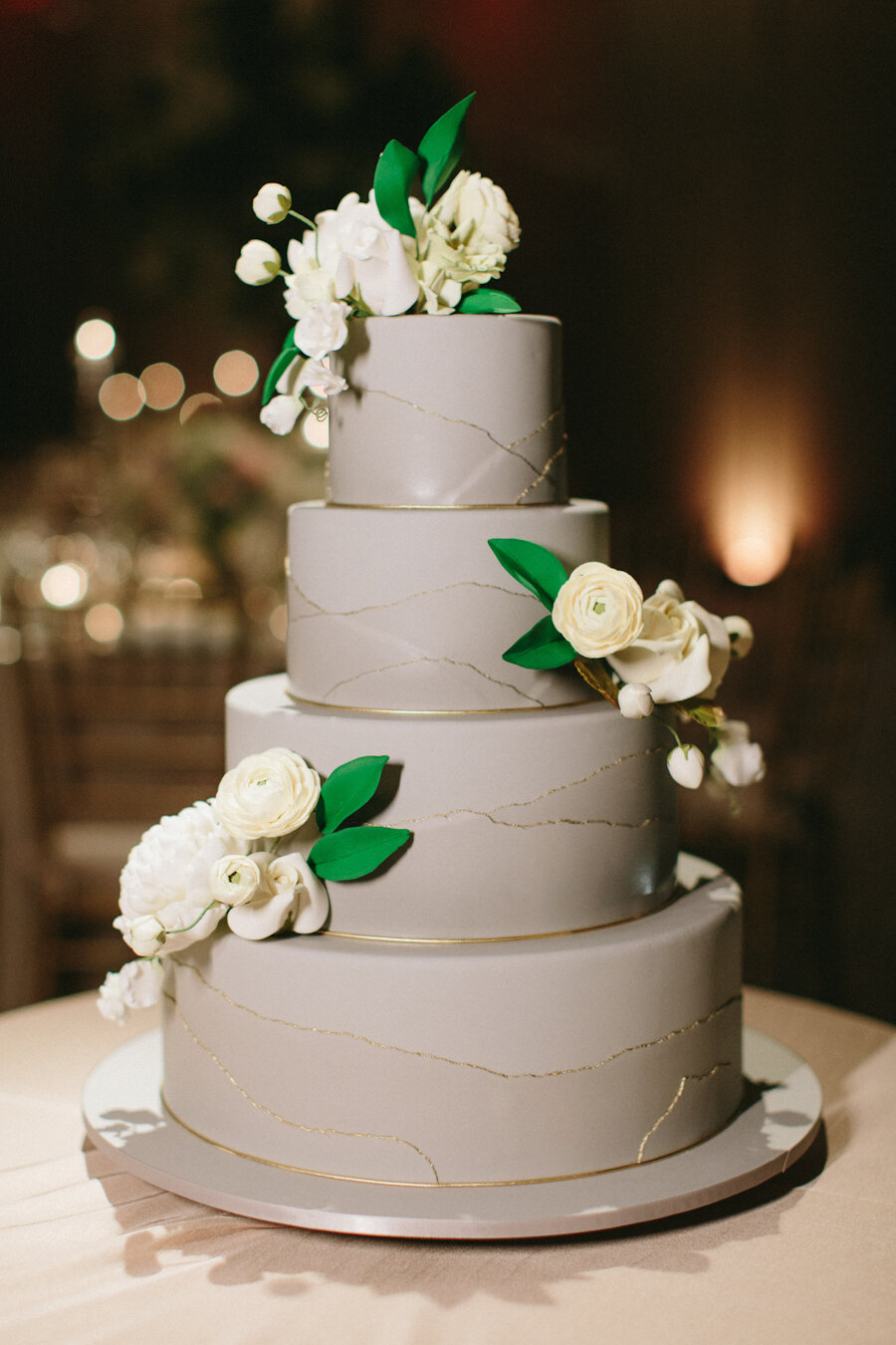 Four Seasons NYC wedding cake in grey with white flowers