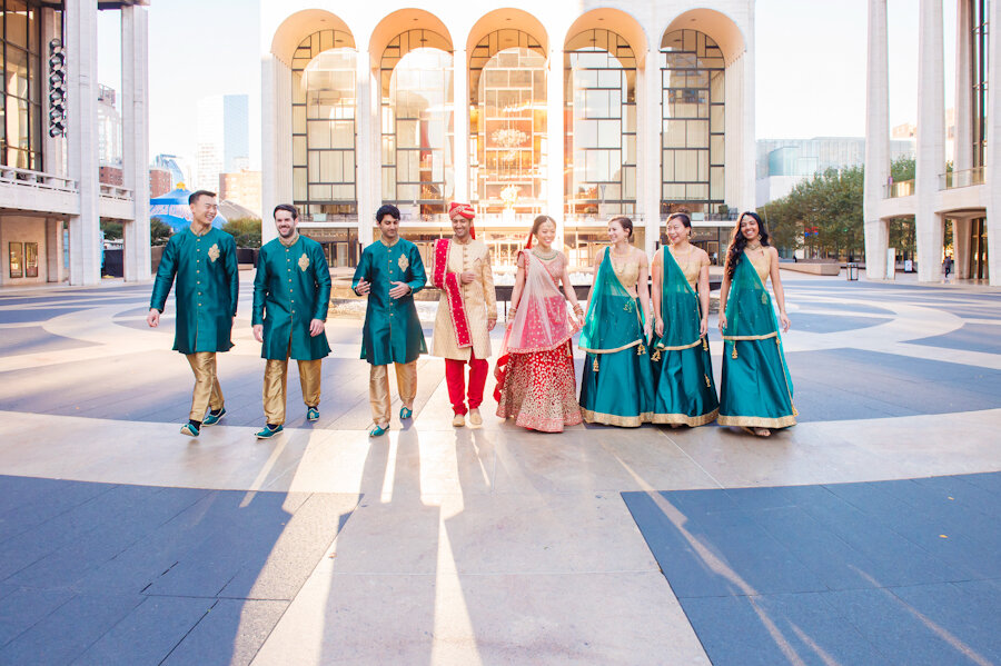 bridal party wearing indian attire in red, green and gold