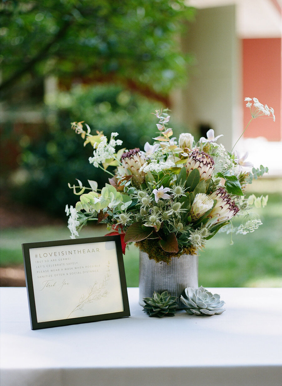 micro wedding flowers on the welcome table