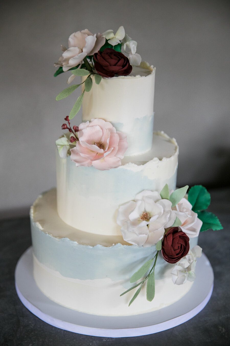 Wedding cake with sugar flowers and ruffled edge