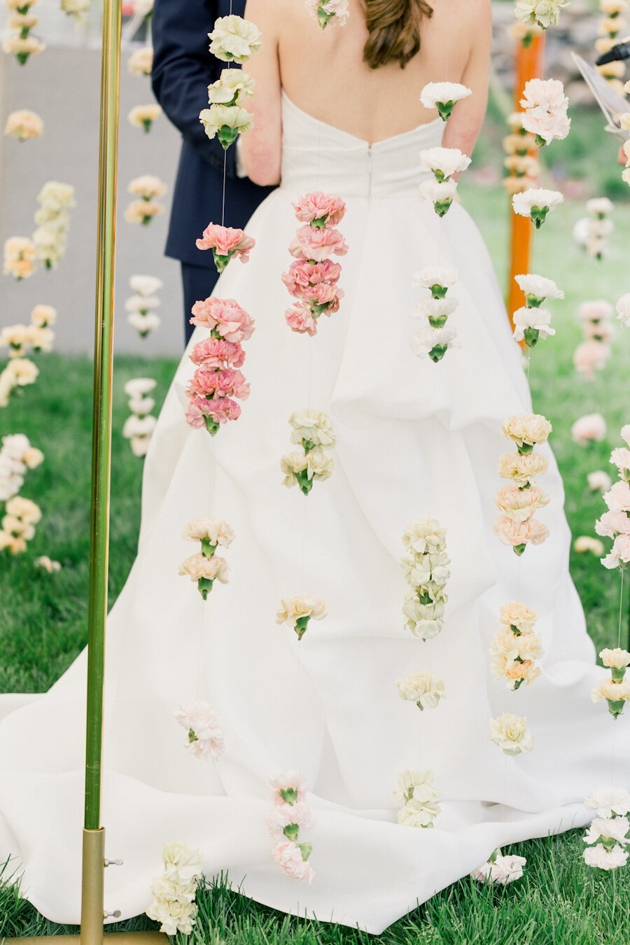outdoor-wedding-ceremony-bride-hanging-flowers.jpg