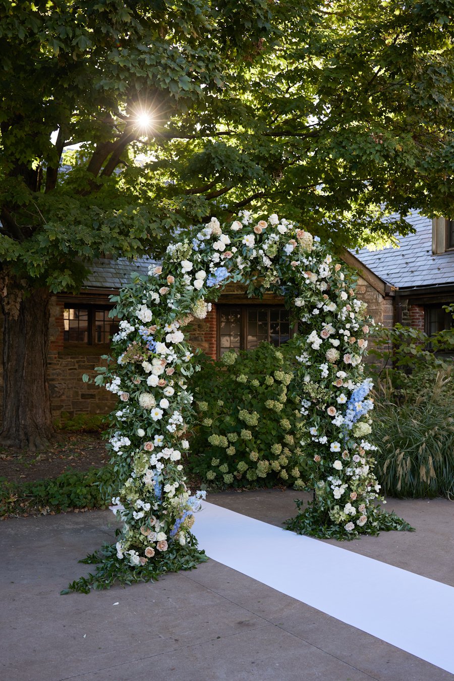 blue hill at stone barns wedding ceremony floral arch