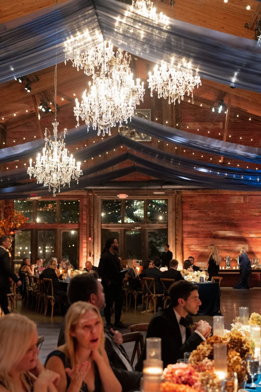 guests-eating-dinner-under-chandeliers.jpg