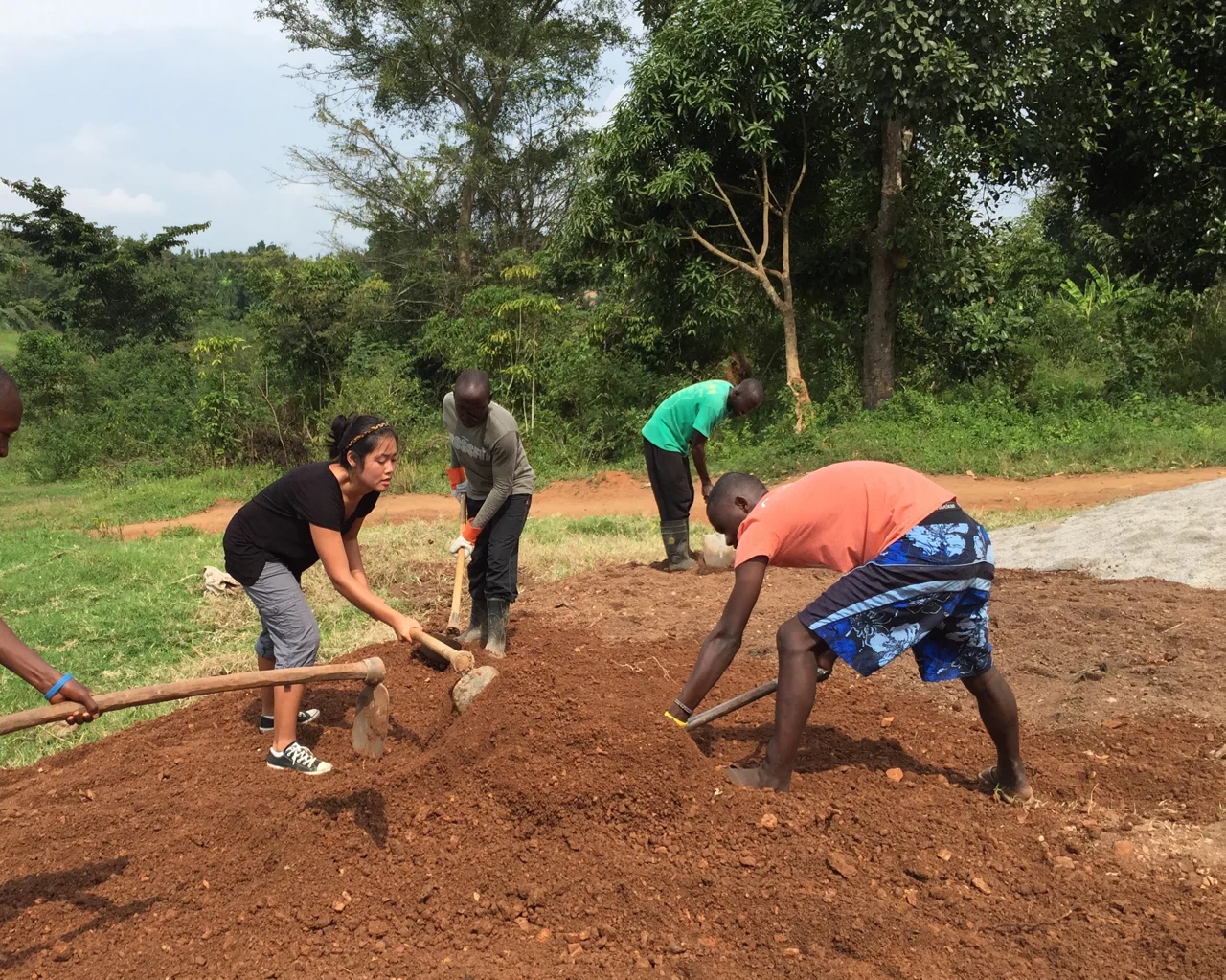 Hannah and JHR residents helping to level ground in front of JHR