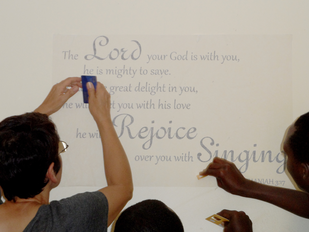 Cindy and JHR residents applying wall art
