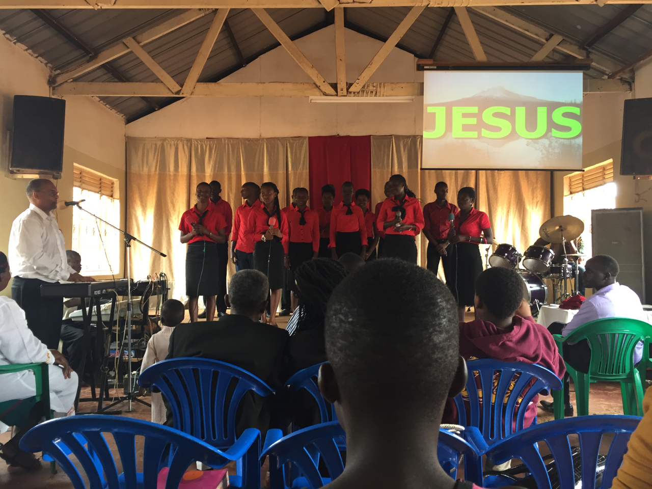 Makinto assisting the choir in leading worship at Bombo Pentecostal Church