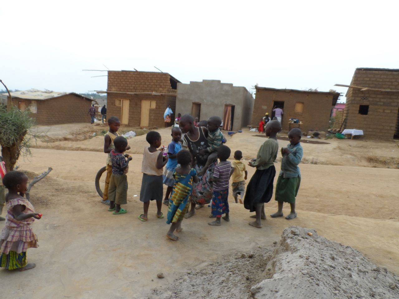 Nakivale children standing outside their mud-brick homes