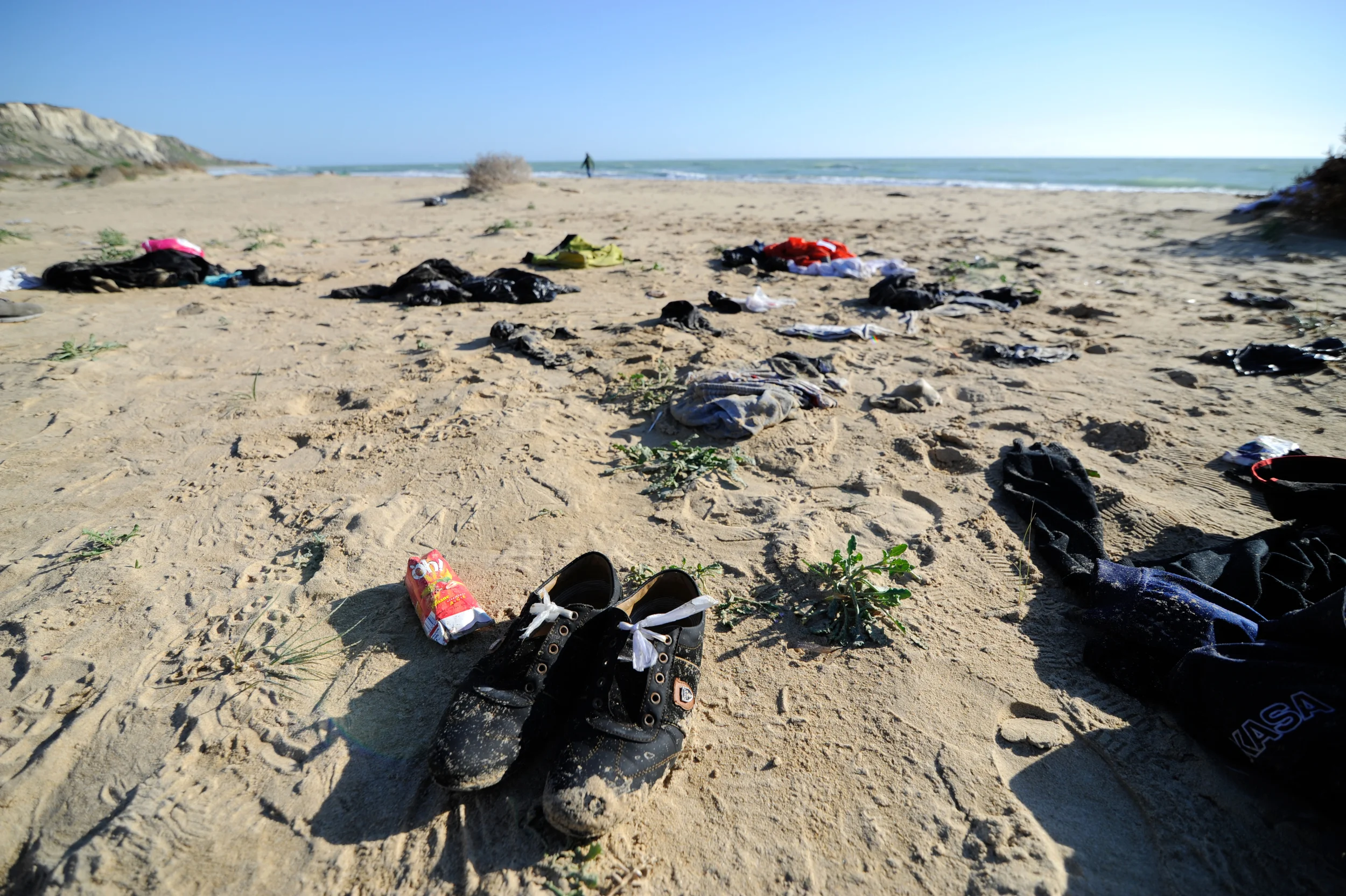 Clothes belonging to migrants lie on the Sicilian beach of Siculiana, Italy February 19, 2016.