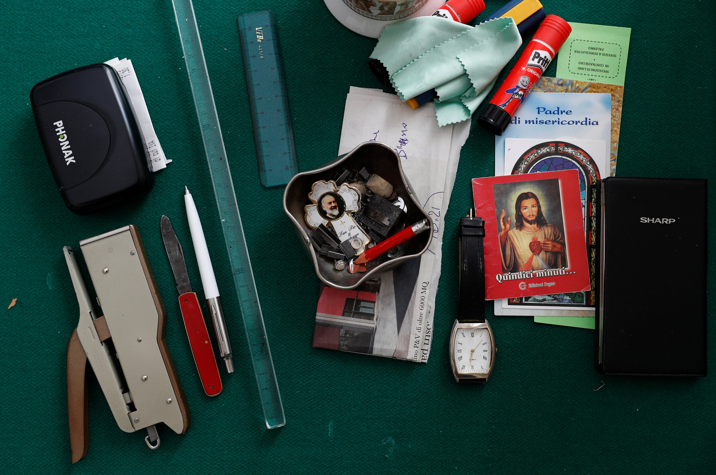  Religious icons sit amongst stationery items belonging to Giuseppe Paterno, 96, Italy's oldest student, a day before he graduates from The University of Palermo with an undergraduate degree in history and philosophy, at his home in Palermo, Italy, J