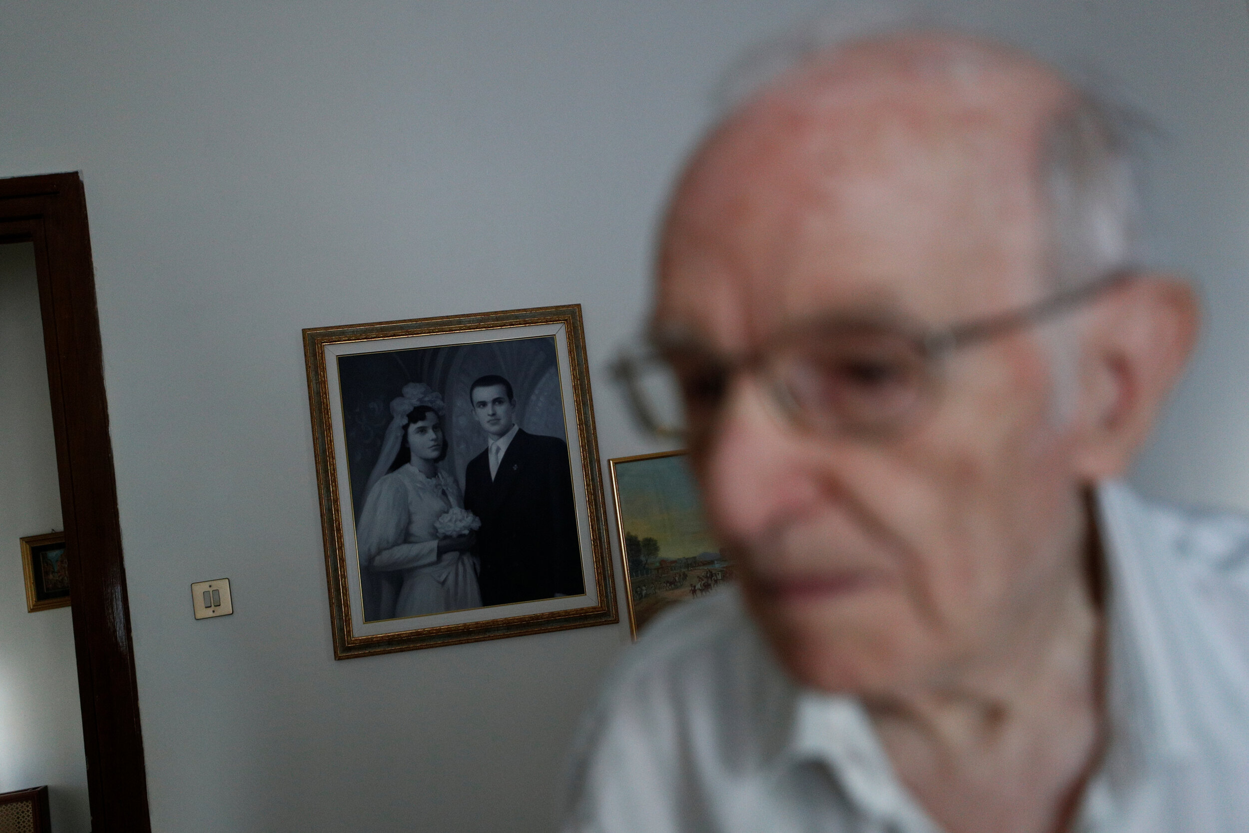  Giuseppe Paterno, 96, Italy's oldest student, walks past a painting hung on the wall depicting his wedding day with his late wife Stefana Battaglia, who died in 2006, and Paterno, two days before he graduates from The University of Palermo with an u